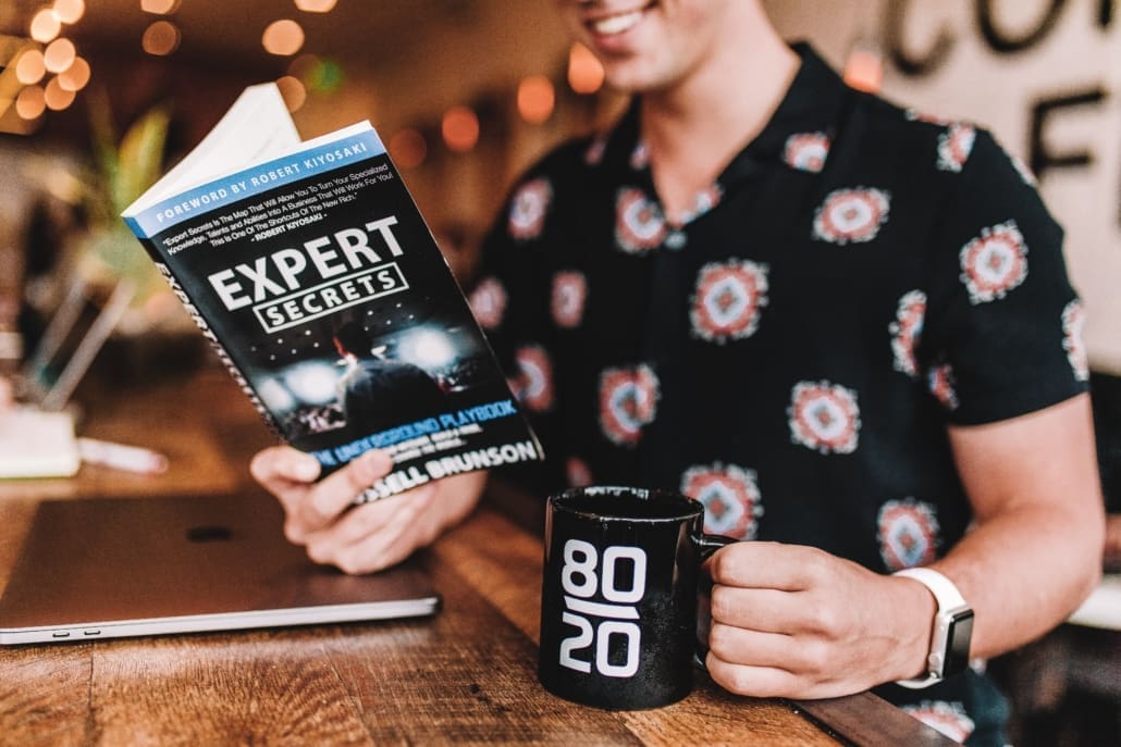 A man reads a book to help imprve his real estate selling skills.