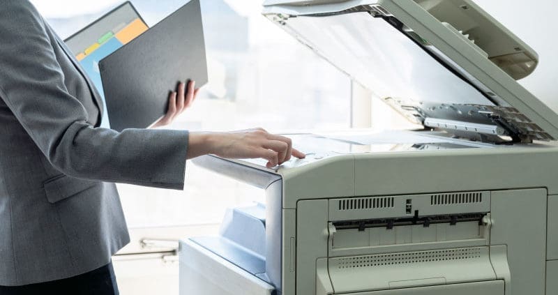 a person using a printer and scanner