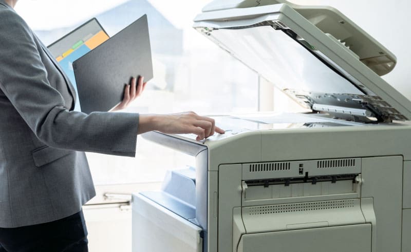 a person using a printer and scanner