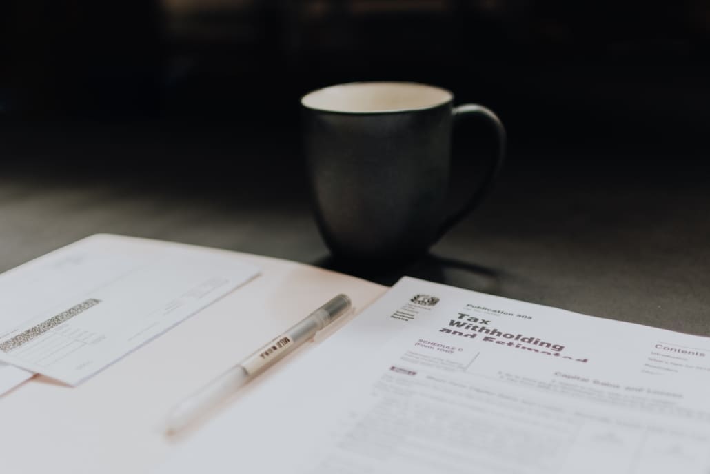 Several tax documents are on a desk.