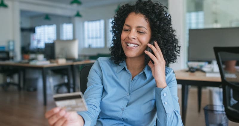 a woman looking at her business credit card