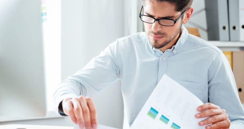 a man looking at accounting documents