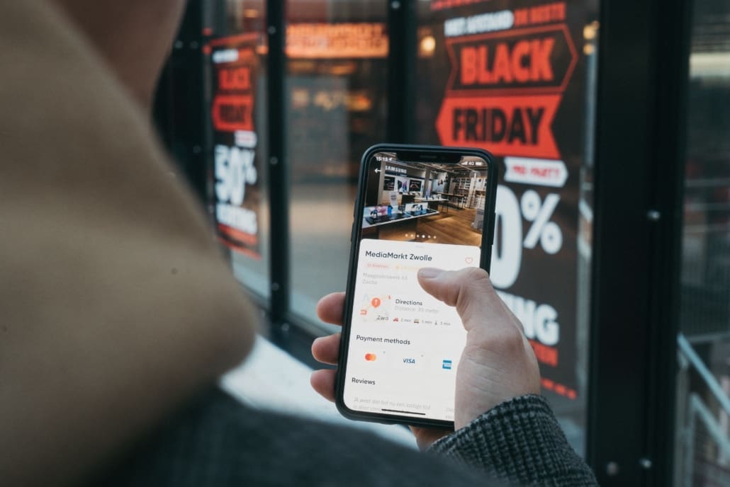 A person checks his phone for sales during Black Friday 