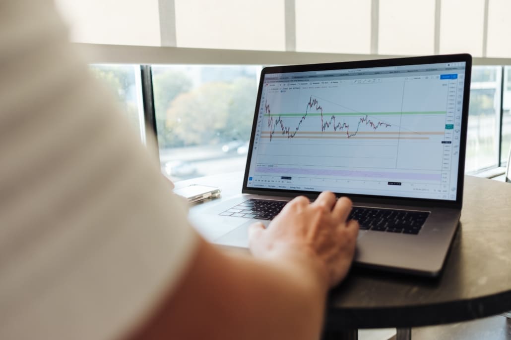 A man looks at an expense report on his laptop