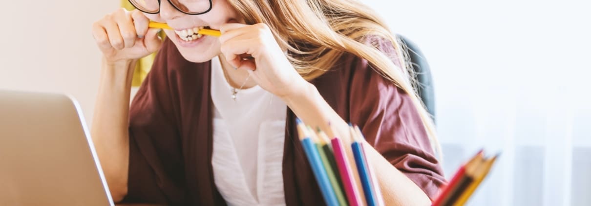 A woman stress bites a pencil going over her Florida business taxes