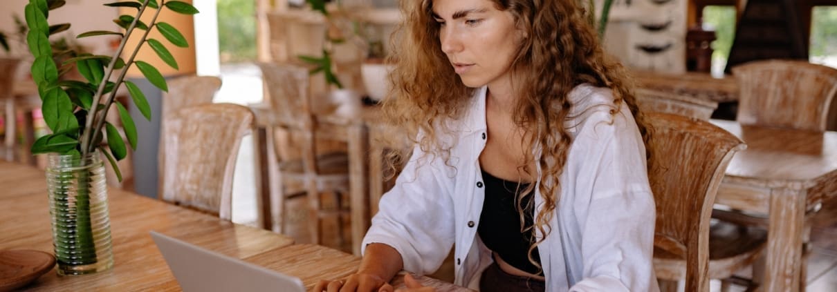 A woman looking at a laptop