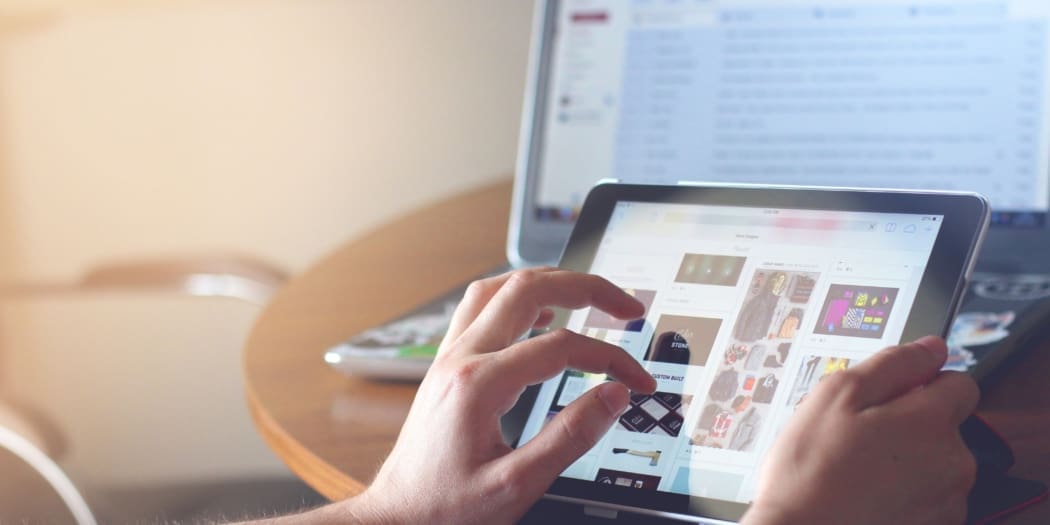 An eCommerce seller looks at her items for sale on a tablet