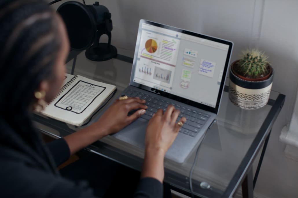 A real estate records her numbers for the week on a laptop,