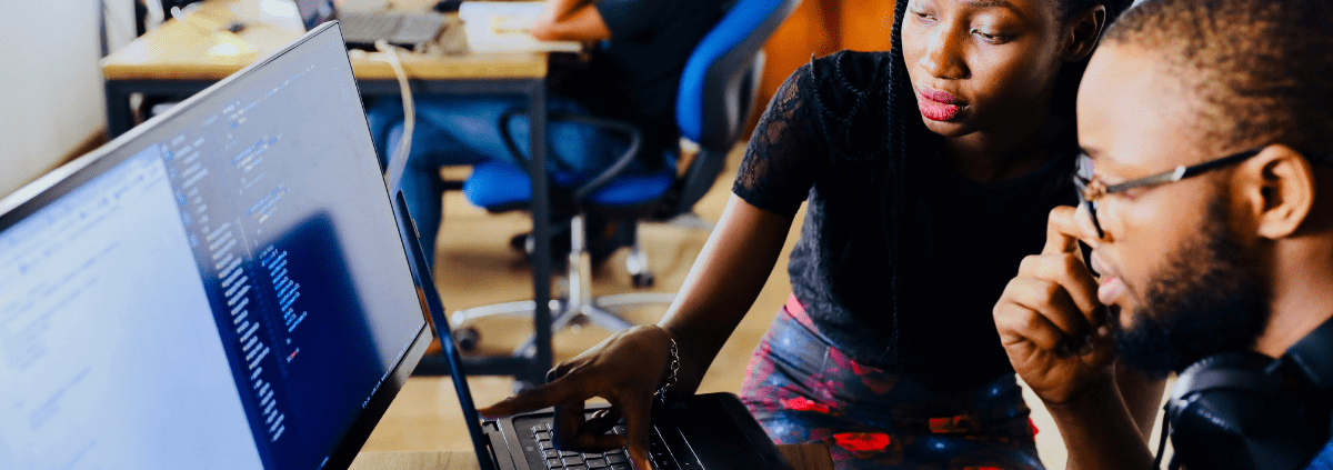 Two young black business owners working on a computer