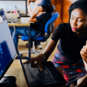 Two young black business owners working on a computer