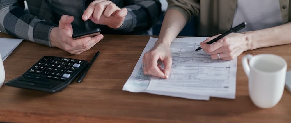 A tax advisor helps a business owner file taxes.
