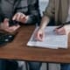 A tax advisor helps a business owner file taxes.