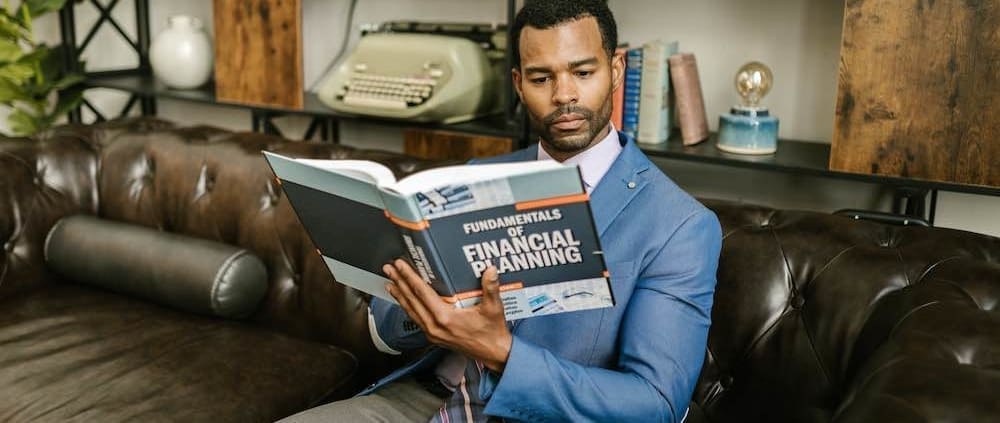 a man reading a book about financial planning