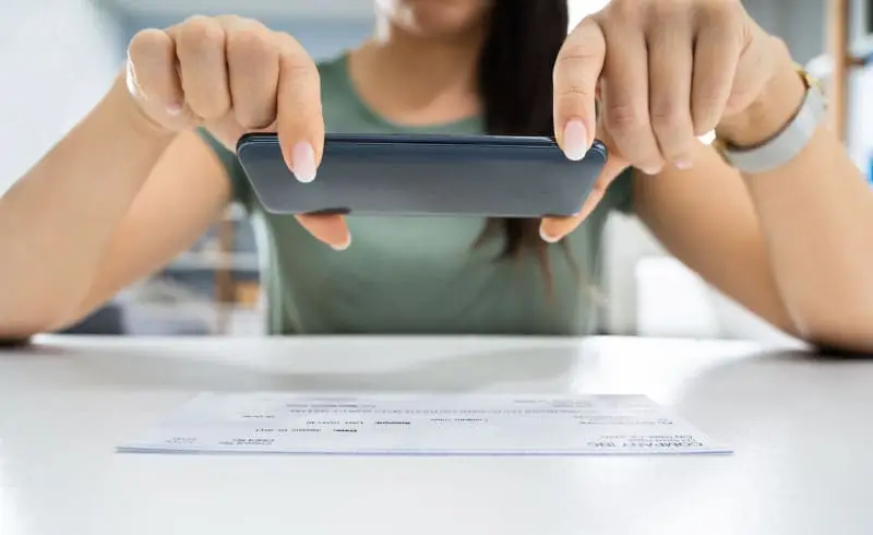 a person taking an image of a bill