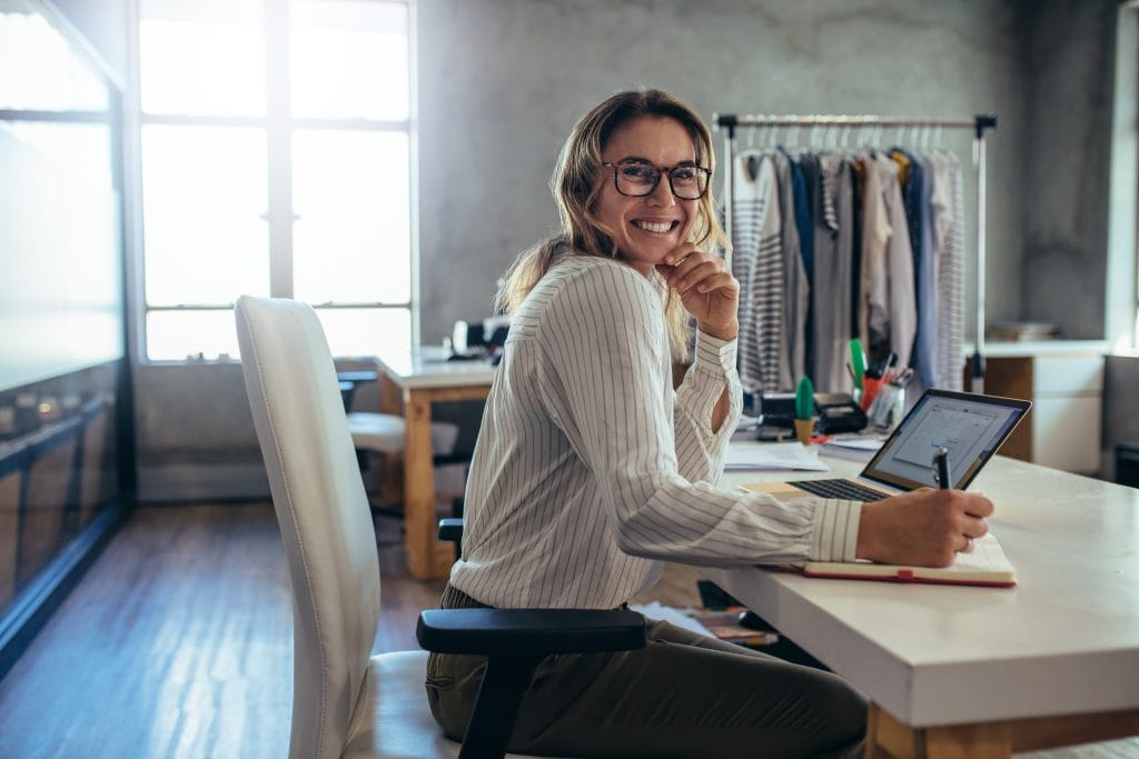 Business owner smiling using Xendoo's services