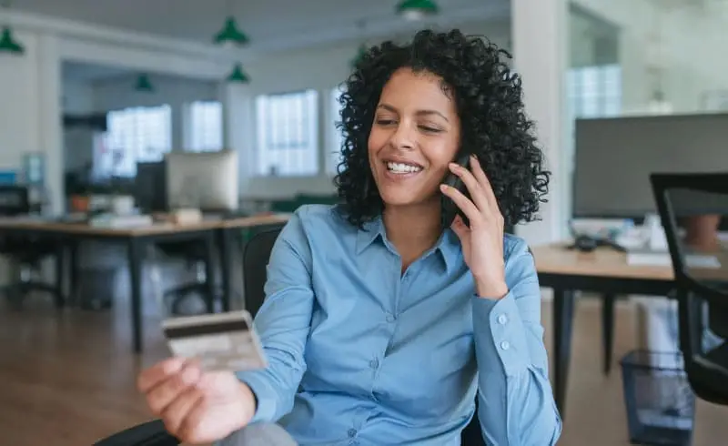 a woman looking at her business credit card