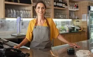 A bar owner standing in front of a POS system