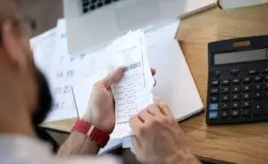 a business owner looking at paper receipts