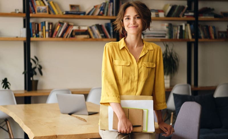 a woman leaning on a desk