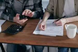 A tax advisor helps a business owner file taxes.