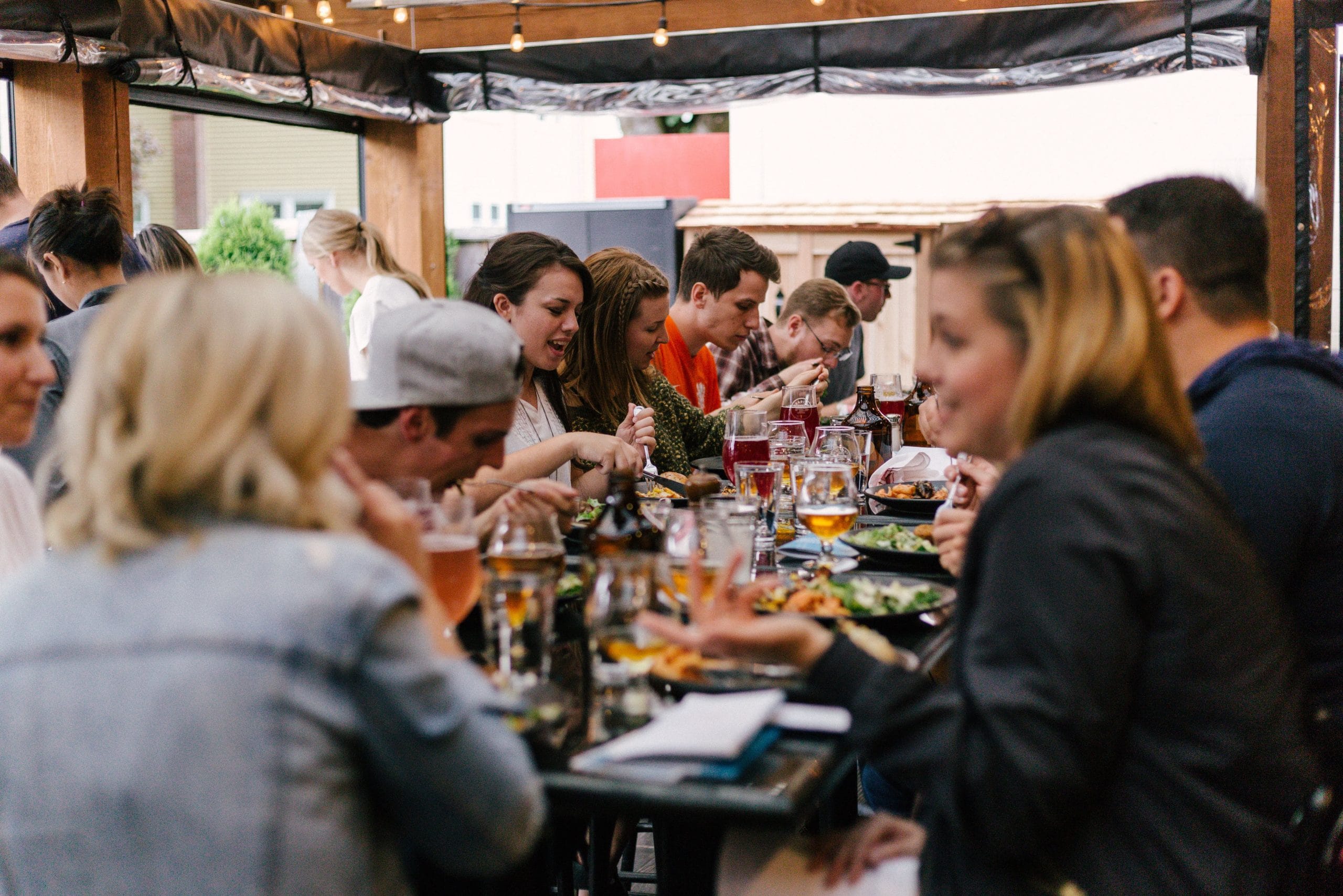 Several people are gathered at a table enjoying a meal.