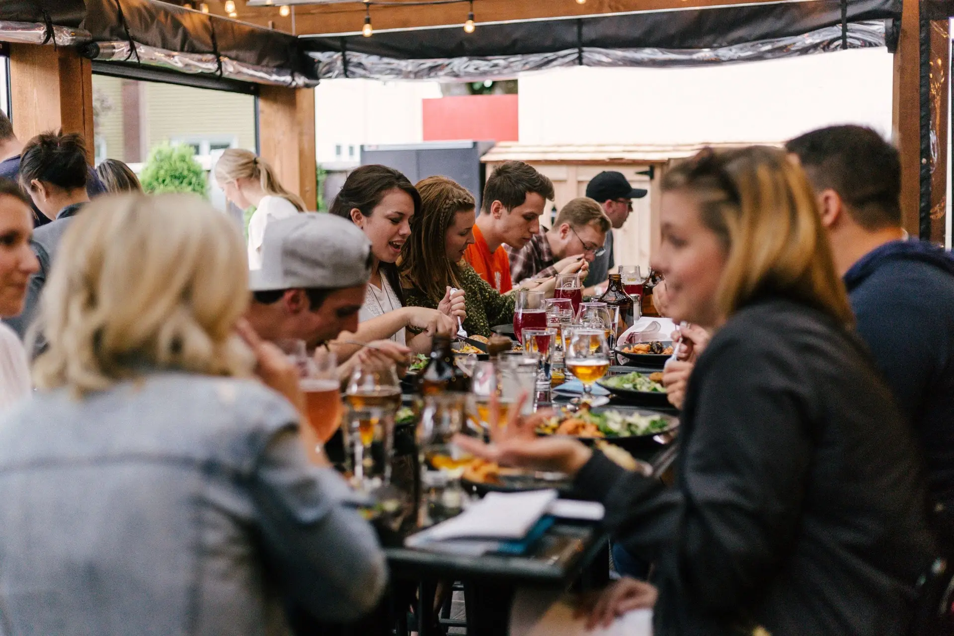 Several people are gathered at a table enjoying a meal.
