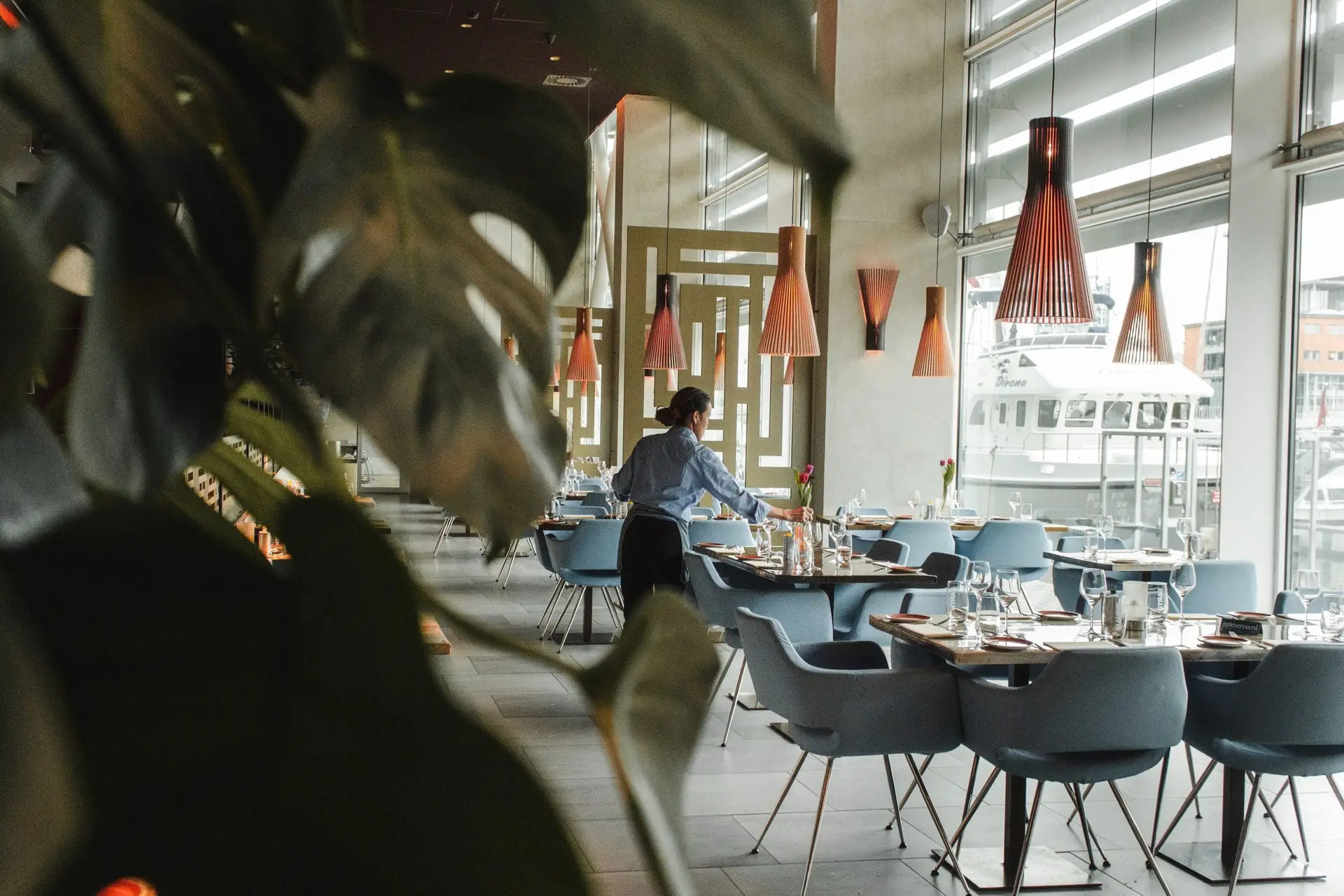 A server sets tables at a restaurant.