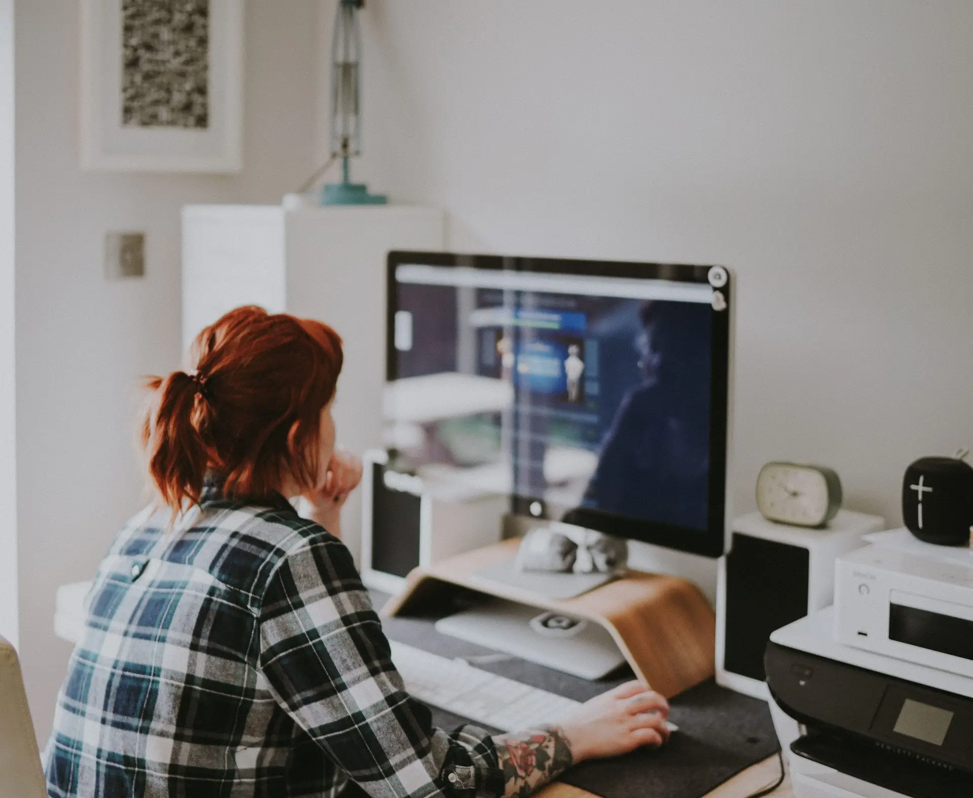 A woman sits at her computer setting up her eCommerce site