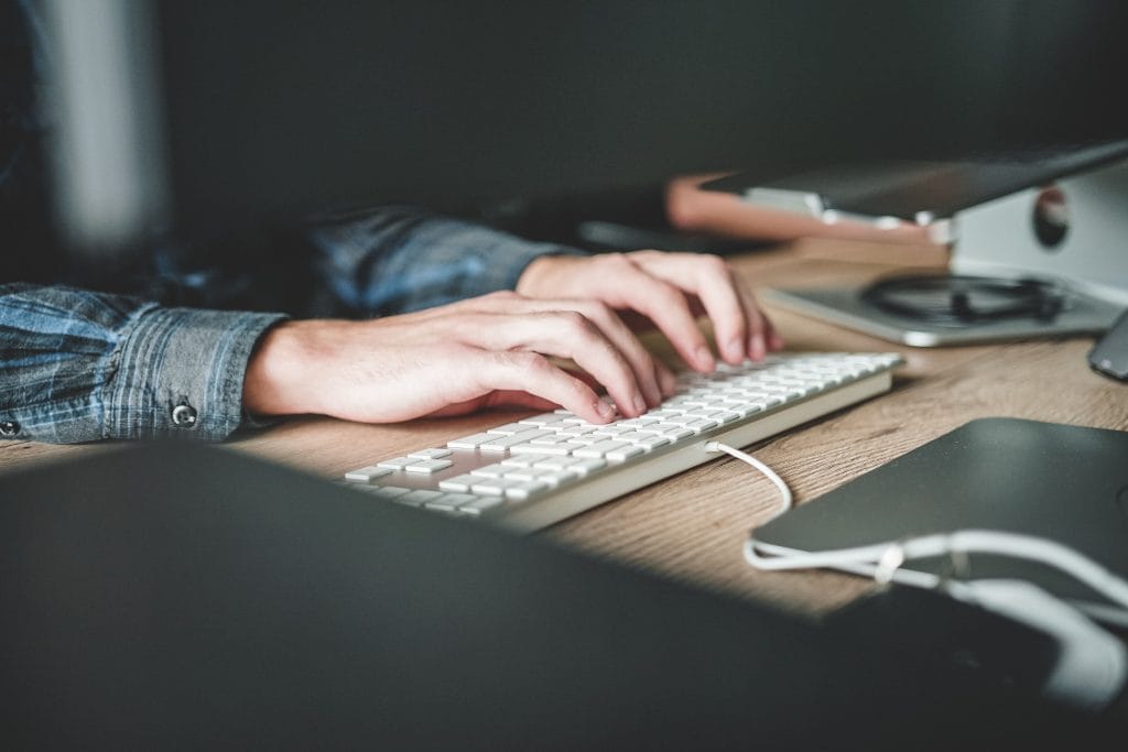 A person works on their laptop.