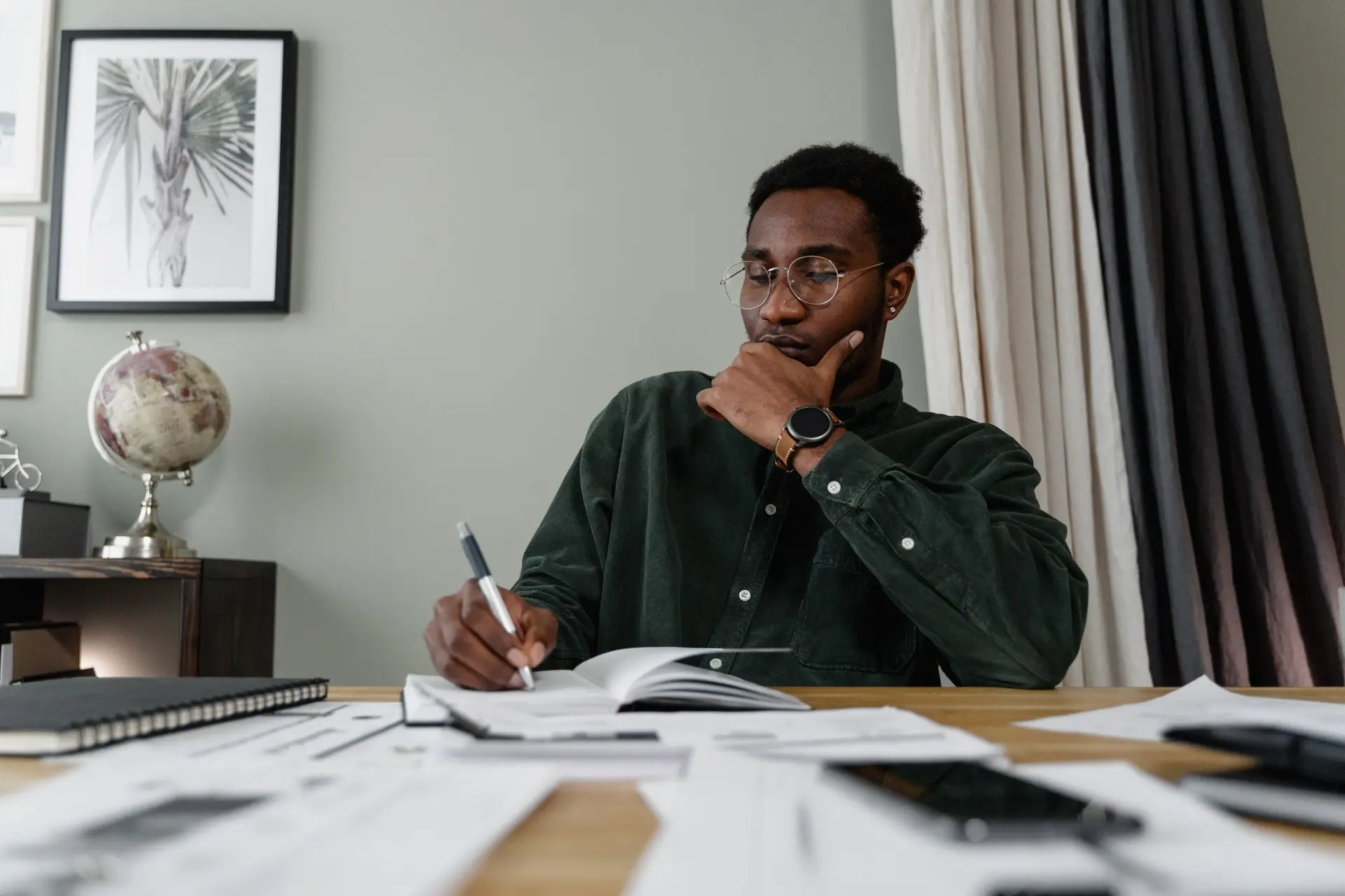A Florida business owner sits at a table with a pile of tax papers.