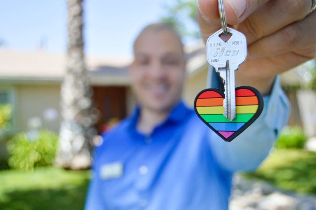A real estate agent holds out the key for his buyer's new home learning about tax tips