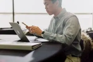 A man looking at his bookkeeping on his laptop